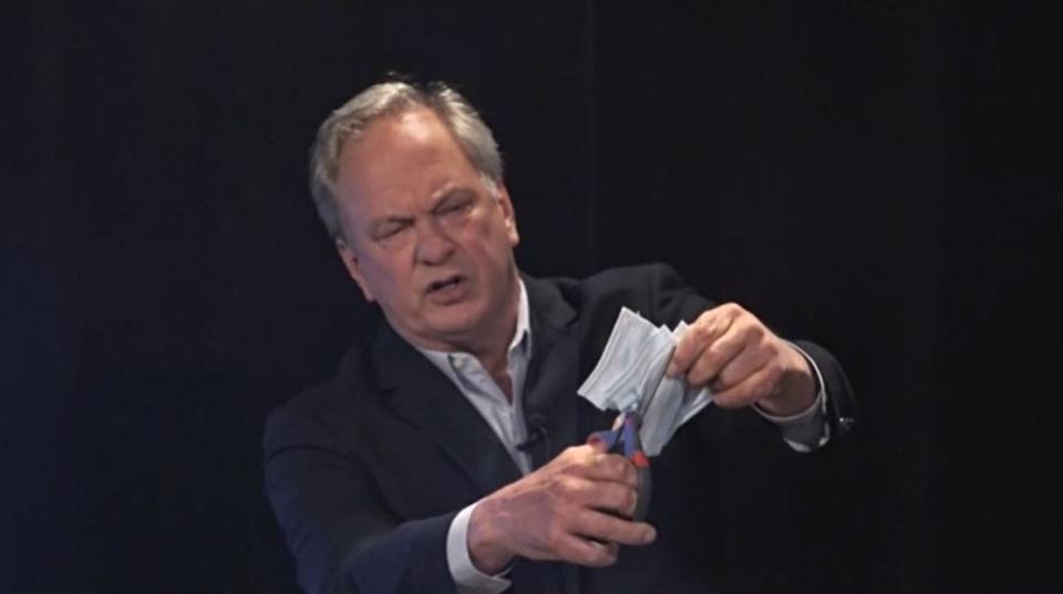 Max Linn uses scissors to cut through face masks during a televised debate Sept. 28, 2020, in Maine's contest for U.S. Senate. Linn became known for his debate antics during the four-way campaign, in which he finished last behind Republican Sen. Susan Collins, who won reelection, and Democrat Sara Gideon and independent Lisa Savage.