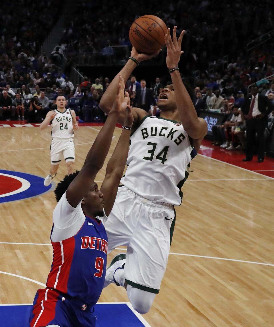 Milwaukee Bucks forward Giannis Antetokounmpo (34) shoots as Detroit Pistons guard Langston Galloway (9) defends during the second half of Game 4 of a first-round NBA basketball playoff series, Monday, April 22, 2019, in Detroit. (AP Photo/Carlos Osorio)