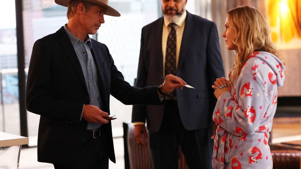 raylan, played by olyphant, hands his card to sandy, played by clemens, also shown, victor williams as wendell