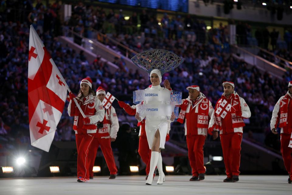 Georgia's flag-bearer Nino Tsiklauri leads her country's contingent during the opening ceremony of the 2014 Sochi Winter Olympics, February 7, 2014. REUTERS/Jim Young (RUSSIA - Tags: OLYMPICS SPORT)