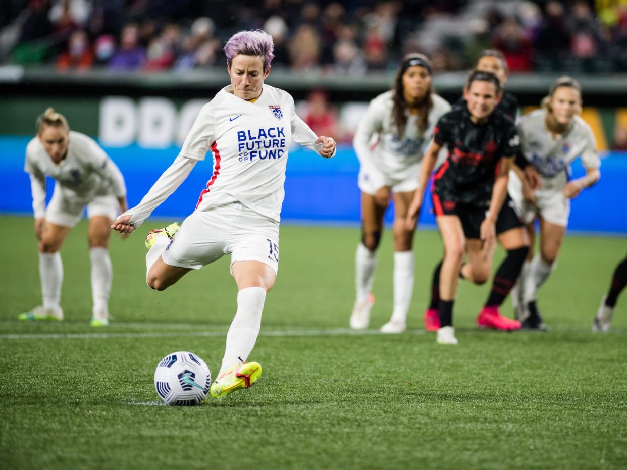 Megan Rapinoe takes a penalty kick for OL Reign during a 2021 NWSL regular-season game against the Portland Thorns.