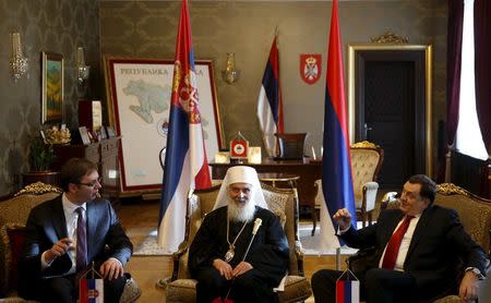 Serbian Orthodox Patriarch Irinej (C), President of the Republika Srpska Milorad Dodik (R) and Serbian Prime Minister Aleksandar Vucic talk in Banja Luka, Bosnia and Herzegovina, January 9, 2015. REUTERS/Dado Ruvic