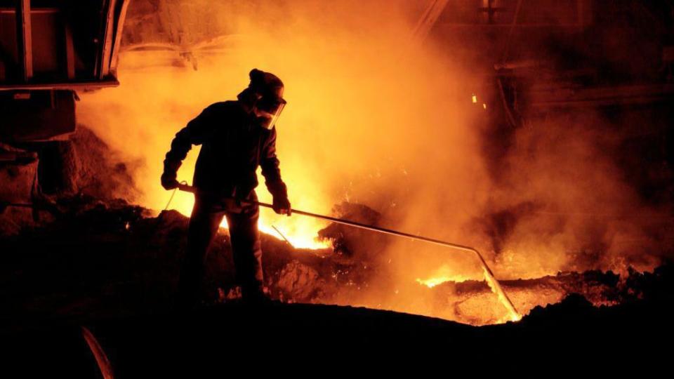A steelworker testing molten iron quality at Blast Furnace 4 in Port Talbot