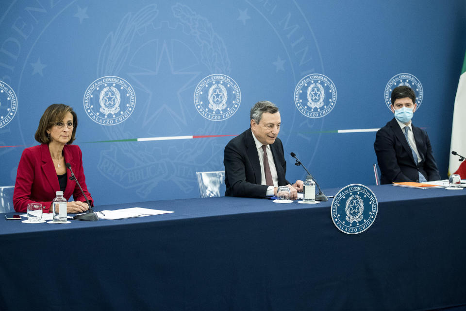 Italian Premier Mario Draghi, center, sits beside Justice Minister Marta Cartabia, left, and Health Minister Roberto Speranza during a press conference at Chigi Palace government office in Rome, Thursday, July 22, 2021. With COVID-19 cases rising again, Italy will start requiring people to have a so-called “green pass” to access venues like gyms, museums and indoor restaurants. Certification that one is vaccinated, has recovered from COVID-19 in the last six months or tested negative in the previous 48 hours will let people dine at indoor restaurants, go to movies, sports events, casinos and other indoor recreational venues. (Roberto Monaldo/LaPresse via AP)