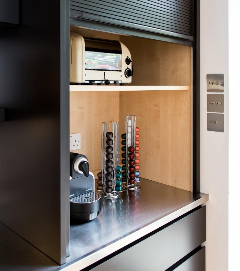 The breakfast area can be hidden away with a sleek tambour door when not in use, like this room from Sola Kitchens.