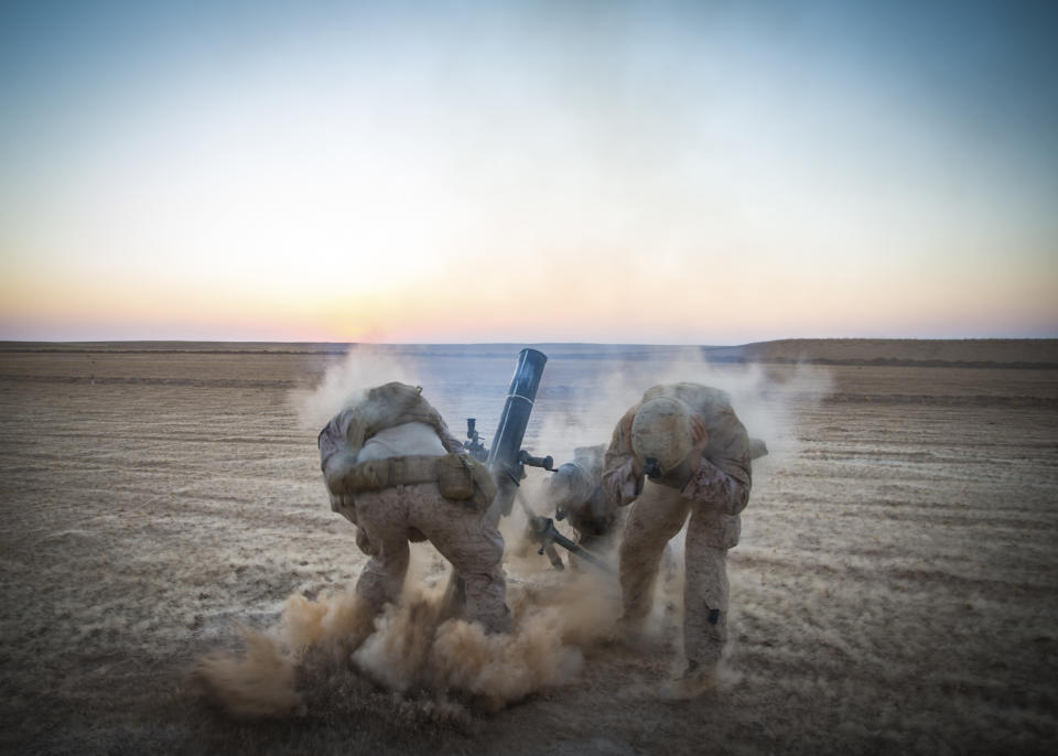 In this Sept. 10, 2018, photo released by the U.S. Marines, Marines with Weapons Company, 3rd Battalion, 7th Marine Regiment, fire mortars from an undisclosed location in Syria. The United States’ main ally in Syria on Thursday, Dec. 20, 2018, rejected President Donald Trump’s claim that Islamic State militants have been defeated and warned that the withdrawal of American troops would lead to a resurgence of the extremist group. (U.S. Marine Corps photo by Cpl. Gabino Perez via AP)
