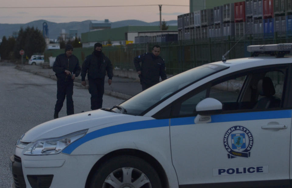 Police secure the area around a factory in the northern city of Komotini, about 800 kilometers (500 miles) northeast of Athens, Thursday, March 1, 2012. An unemployed man shot and wounded two people and took two others hostage at the plastics factory. The shooter, who was fired from the factory eight months ago, burst into the site with a with a shotgun, wounding a member of the management and another employee, police said. (AP Photo/Nikolas Giakoumidis)