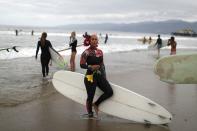 A woman prepares to surf at The Black Girls Surf paddle-out in memory of George Floyd, who died in Minneapolis police custody, in Santa Monica