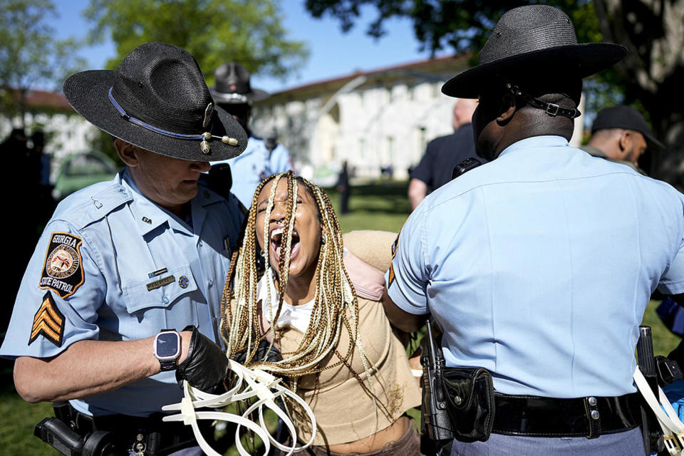 Georgia State Patrol officers detain a demonstrator on the campus of Emory University  (Mike Stewart / AP)