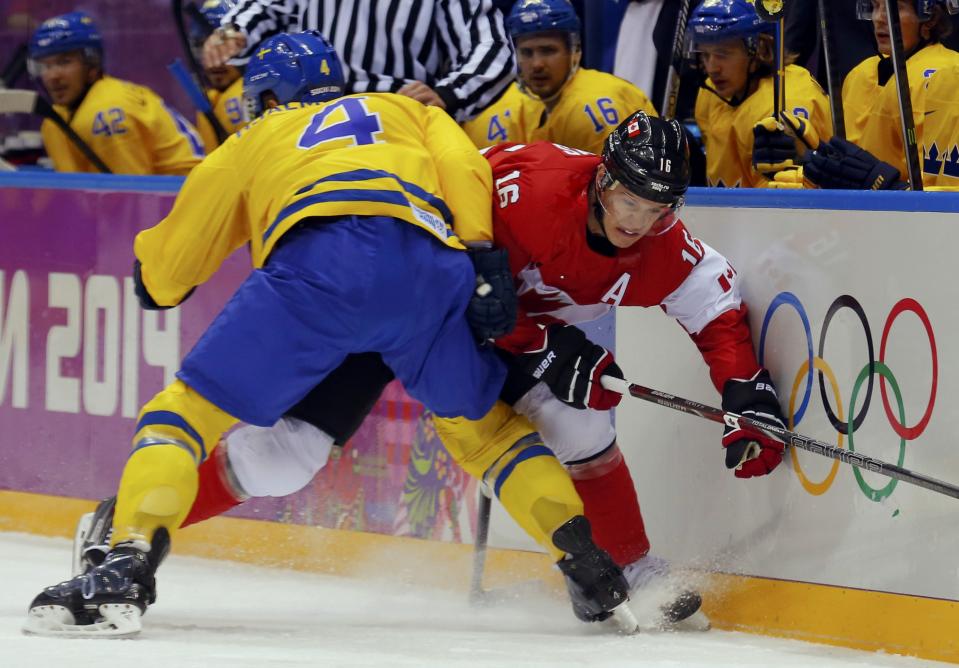 Sweden's Hjalmarsson checks Canada's Toews during the first period of their men's ice hockey gold medal match 
at the Sochi 2014 Winter Olympic Games