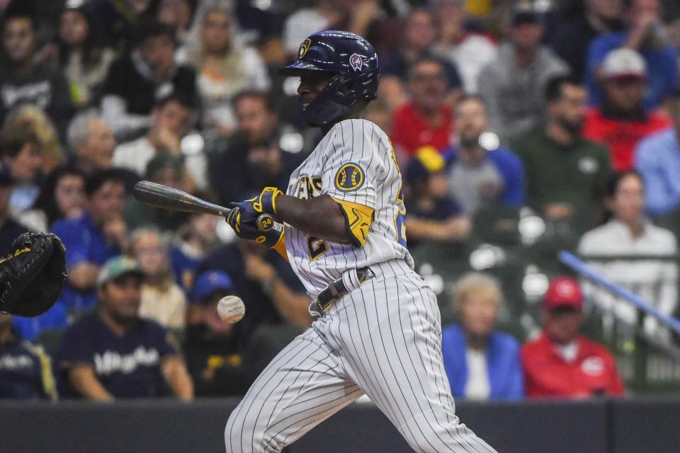 Milwaukee Brewers' Andrew McCutchen gets hit by a pitch from Cincinnati Reds pitcher Justin Dunn during the third inning of a baseball game, Sunday, September 11, 2022, in Milwaukee. (AP Photo/Kenny Yoo)