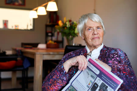 Clara Jas reads a newspaper in her house in Zwolle, the Netherlands April 3, 2018. REUTERS/Michael Kooren/Files