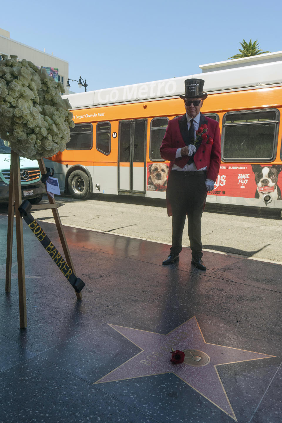 Gregg Donovan pays his respects as a flower lies on popular game show host Bob Barker's Walk of Fame star in Los Angeles, Saturday, Aug. 26, 2023. A publicist says Barker, a household name for a half-century as host of "Truth or Consequences" and "The Price Is Right," has died at his home in Los Angeles. Barker was 99. (AP Photo/Damian Dovarganes)