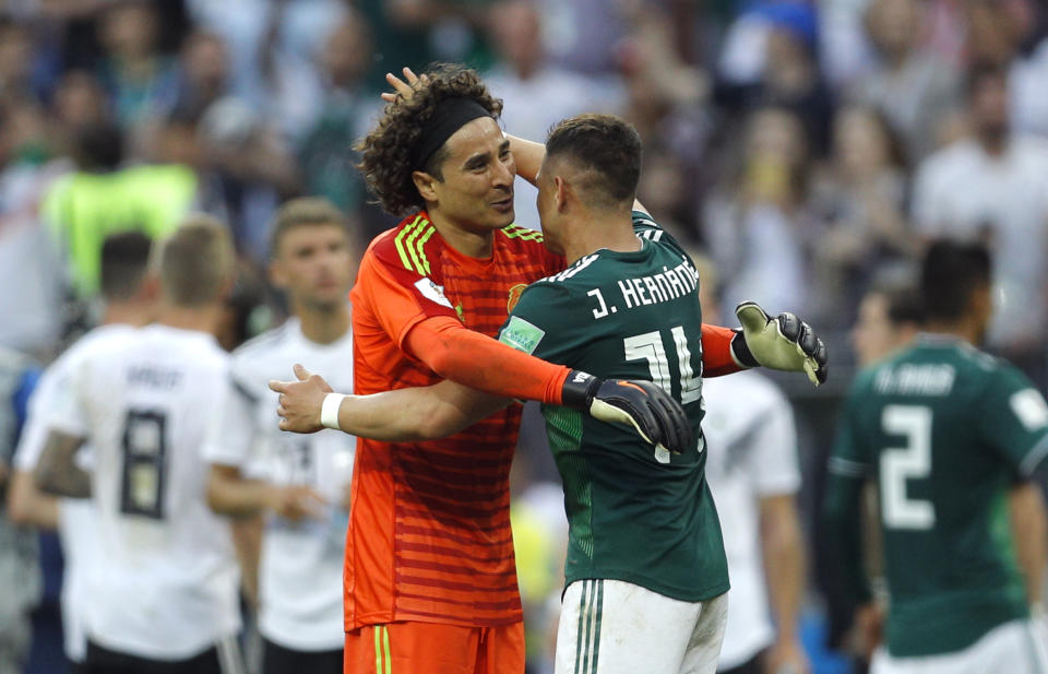 Mexico’s Javier Hernandez and goalkeeper Guillermo Ochoa, left, celebrate at the end of the group F match between Germany and Mexico at the 2018 soccer World Cup in the Luzhniki Stadium in Moscow, Russia, Sunday, June 17, 2018. (AP Photo/Victor R. Caivano)