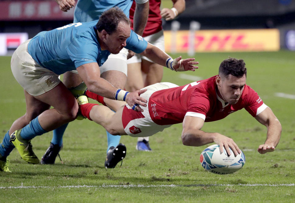 Wales' Tomos Williams scores a try during the Rugby World Cup Pool D game at Kumamoto Stadium between Wales and Uruguay in Kumamoto, Japan, Sunday, Oct. 13, 2019. (AP Photo/Aaron Favila)