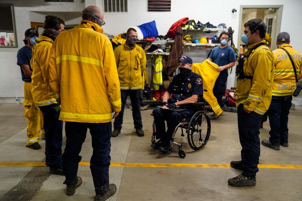 Menlo Park Fire Chief Harold Schapelhouman chats with volunteers at the Boulder Creek Fire District