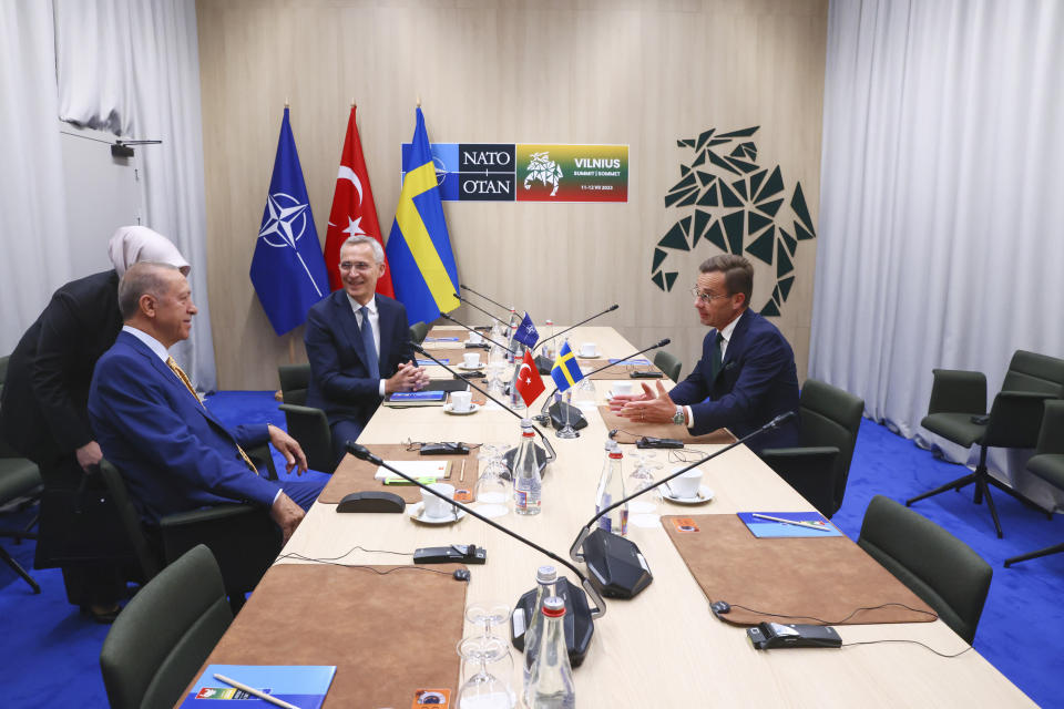 FILE - NATO Secretary General Jens Stoltenberg, center, speaks with Turkey's President Recep Tayyip Erdogan, left, and Sweden's Prime Minister Ulf Kristersson during a meeting ahead of a NATO summit in Vilnius, Lithuania, Monday, July 10, 2023. Turkish President Recep Tayyip Erdogan's abrupt approval of Sweden's NATO bid came after a year of objections to Stockholm to joining the defense alliance. (Yves Herman, Pool Photo via AP, File)