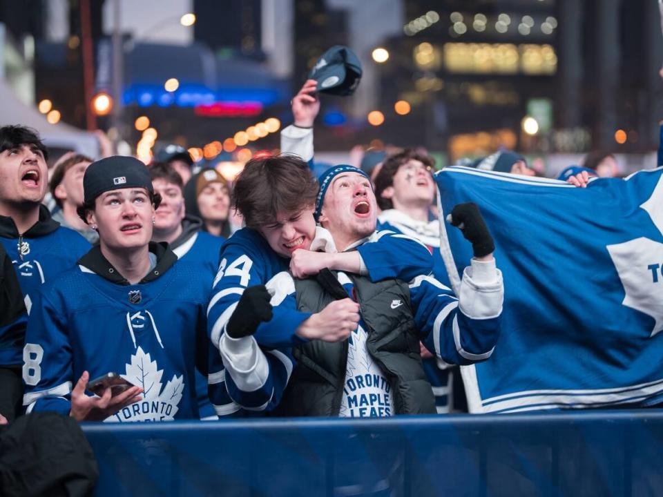 Fans watch the Toronto Maple Leafs play against the Boston Bruins at a tailgate outside Scotiabank Arena on Wednesday night.  (Isidore Champagne/CBC - image credit)