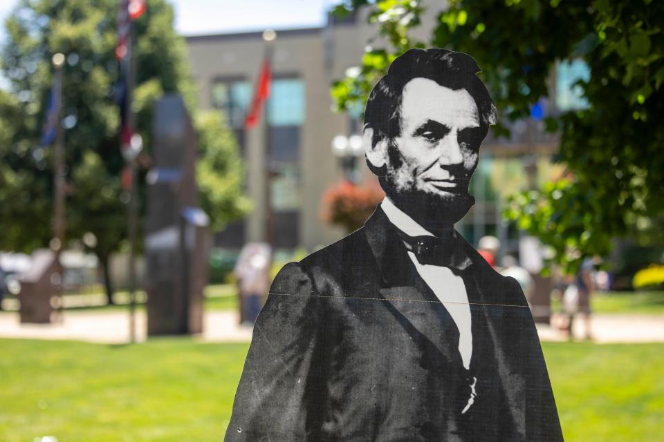 A cardboard cutout of Abraham Lincoln stands Saturday, June 8, 2024, on the Portage County Courthouse Lawn for visitors to take photos during Ravenna’s 225th Birthday Celebration. Abraham Lincoln visited the city of Ravenna by railroad on Feb. 15, 1861.