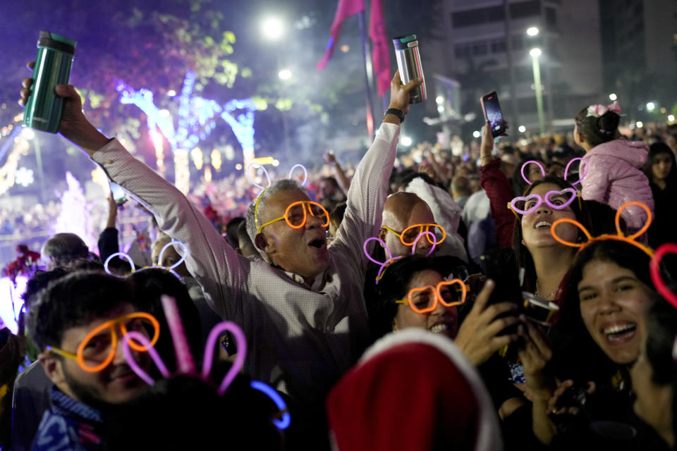 People celebrate New Year at Plaza Altamira in Caracas, Venezuela, early Jan. 1, 2024. (AP Photo/Matias Delacroix)
