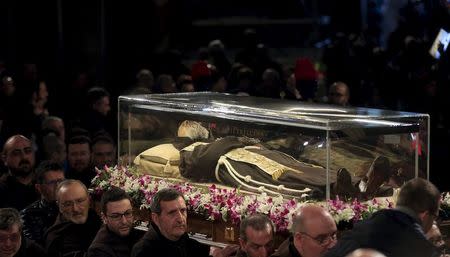 The exhumed body of the mystic saint Padre Pio is carried inside the Catholic church of San Lorenzo fuori le Mura in Rome, February 3, 2016. REUTERS/Yara Nardi