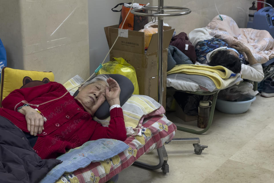 Elderly patients rest along a corridor of the emergency ward as they receive intravenous drips in Beijing, Thursday, Jan. 5, 2023. Patients, most of them elderly, are lying on stretchers in hallways and taking oxygen while sitting in wheelchairs as COVID-19 surges in China's capital Beijing. (AP Photo/Andy Wong)
