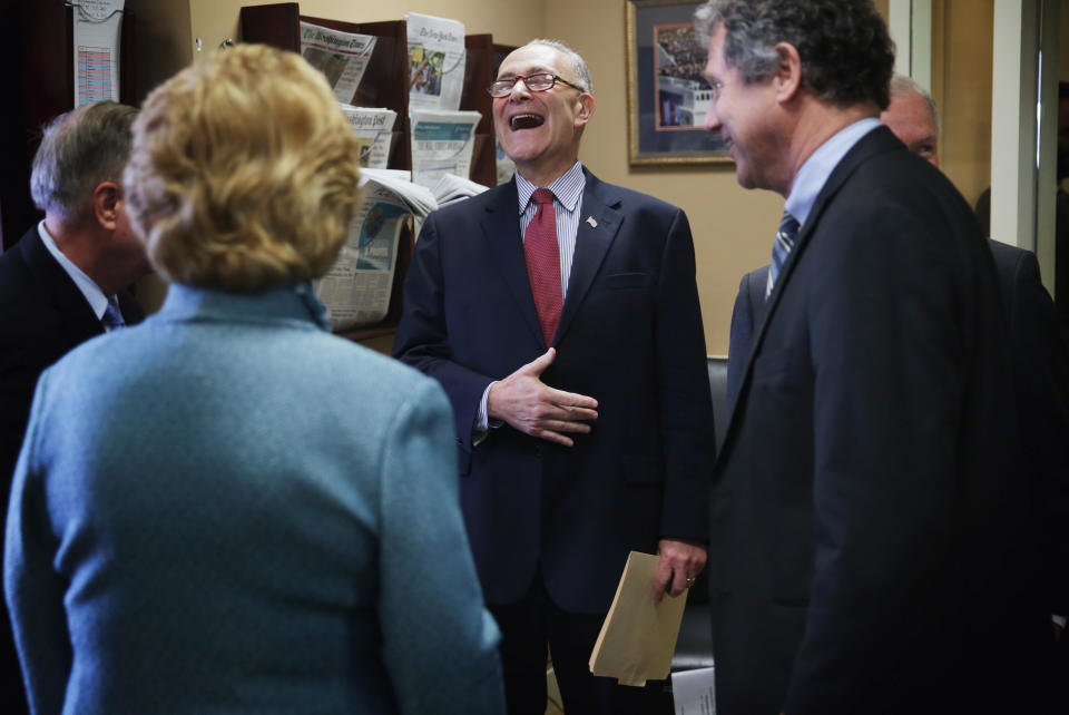 Sen. Charles Schumer (D-N.Y.) (3rd L) laughs as he talks to (L-R) Sen. Lindsey Graham (R-S.C.), Sen. Debbie Stabenow (D-Mich.), Sen. Sherrod Brown (D-Ohio) and Sen. Jeff Sessions (R-Ala.) before a news conference on currency and trade Feb. 10, 2015, on Capitol Hill.