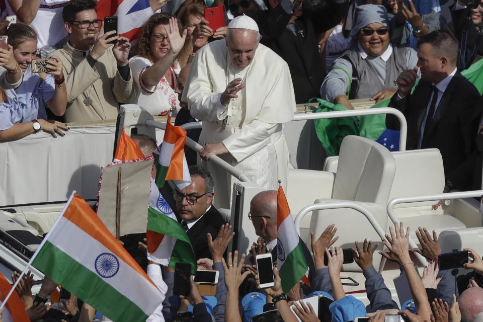 Pope Francis is driven through the crowd in St. Peter's Square at the Vatican, Sunday, Oct. 13, 2019. Francis presided over Mass on Sunday in a packed St. Peter's Square to declare Cardinal John Henry Newman and four women saints. (AP Photo/Alessandra Tarantino)