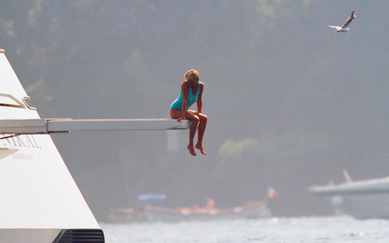 Diana, Princess of Wales, sitting on the diving board of Mohamed Fayed's private yacht, Jonikal - This content is subject to copyright.