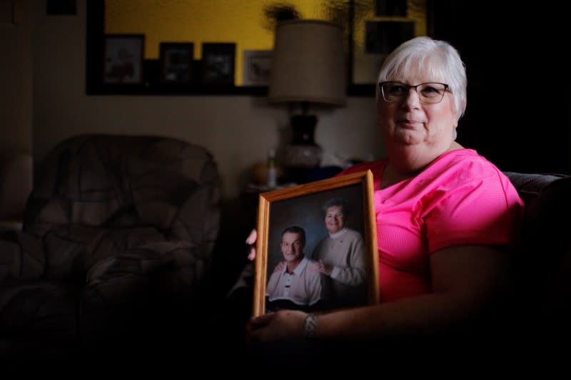 Debbie de los Angeles, whose mother died from coronavirus disease, poses for a portrait at her home in Monroe
