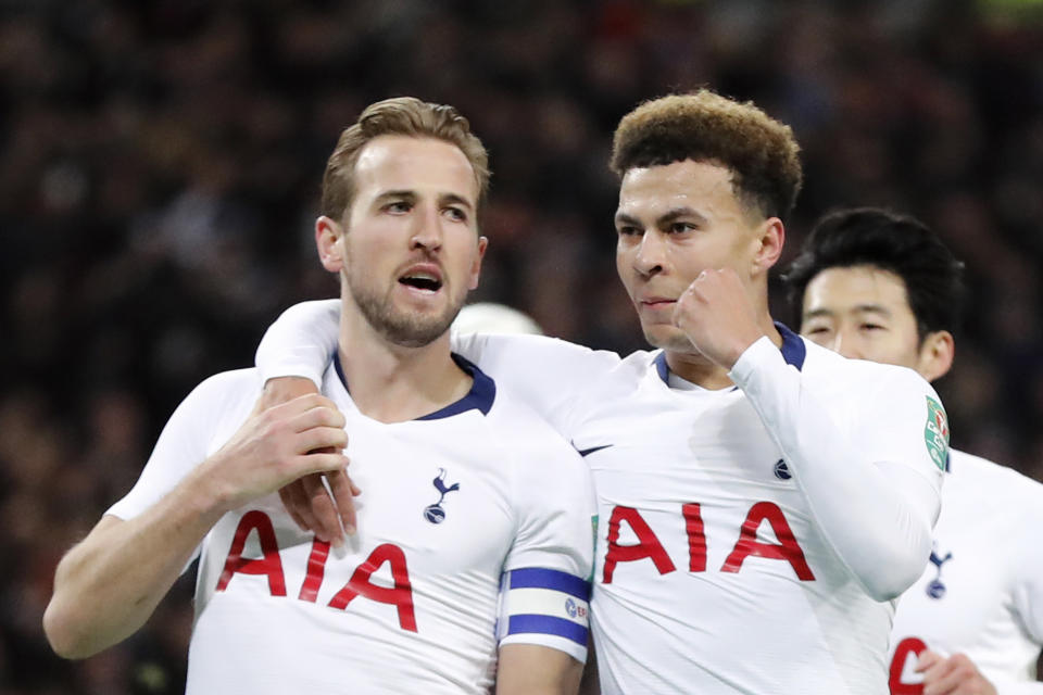 Tottenham's Harry Kane, left, celebrates with teammate Dele Alli after scoring his side first goal during the English League Cup semifinal first leg soccer match between Tottenham Hotspur and Chelsea at Wembley Stadium in London, Tuesday, Jan. 8, 2019. (AP Photo/Frank Augstein)