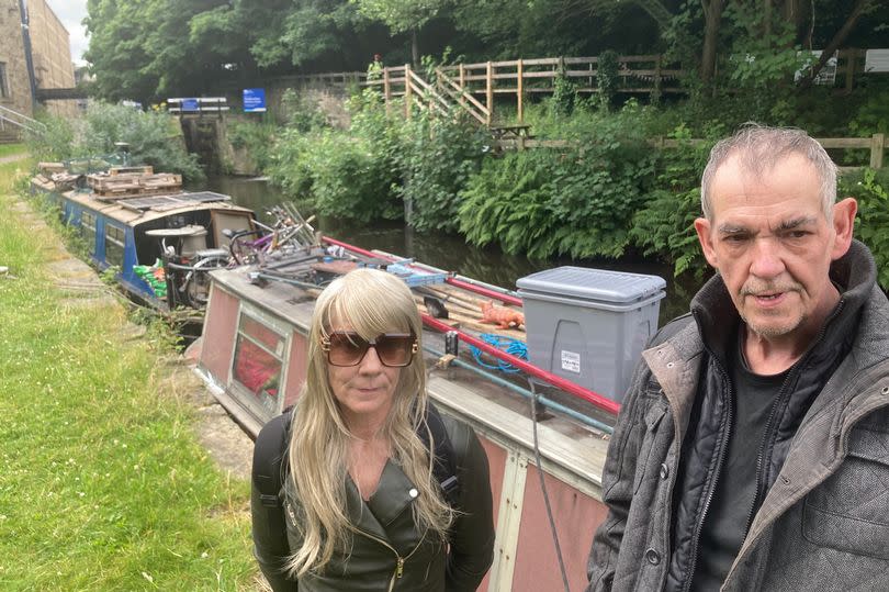 David Brook and Christine Lavin say they are 'marooned' on the canal in Huddersfield due to 'red-tape' problems. They are pictured beside lock 1E which is locked shut with a chain and padlock