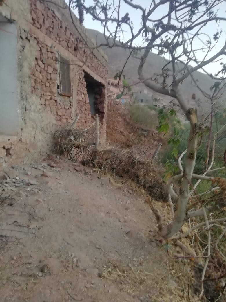 Broken building on mountainous terrain after an earthquake