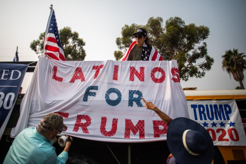 People decorate a truck with a banner reading "Latinos for Trump" during a Pro-Trump car caravan on Ventura Blvd in Studio City, a neighborhood in the city of Los Angeles, on September 13, 2020, amid the coronavirus pandemic. (Photo by Apu GOMES / AFP) (Photo by APU GOMES/AFP via Getty Images)