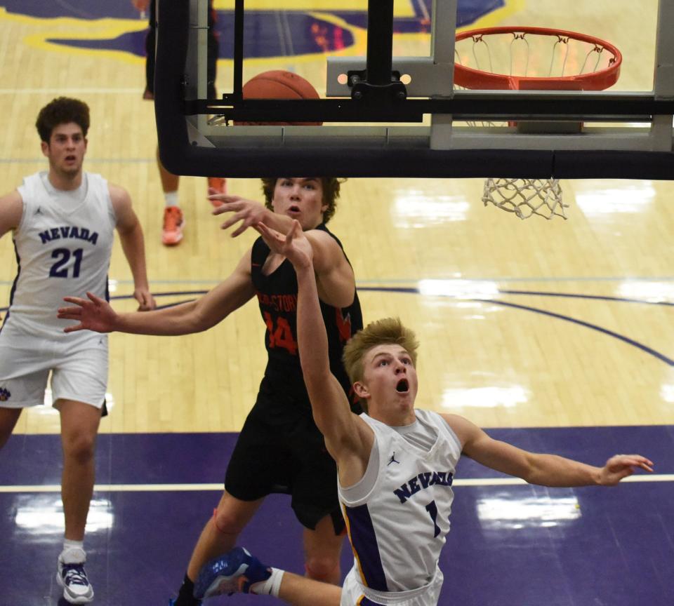 Nevada's Kyle Kingsbury goes by Roland-Story's Dillon Lettow for a layup during the Cubs' 79-56 loss to the Norsemen Dec. 6 at the Nevada High School Field House.