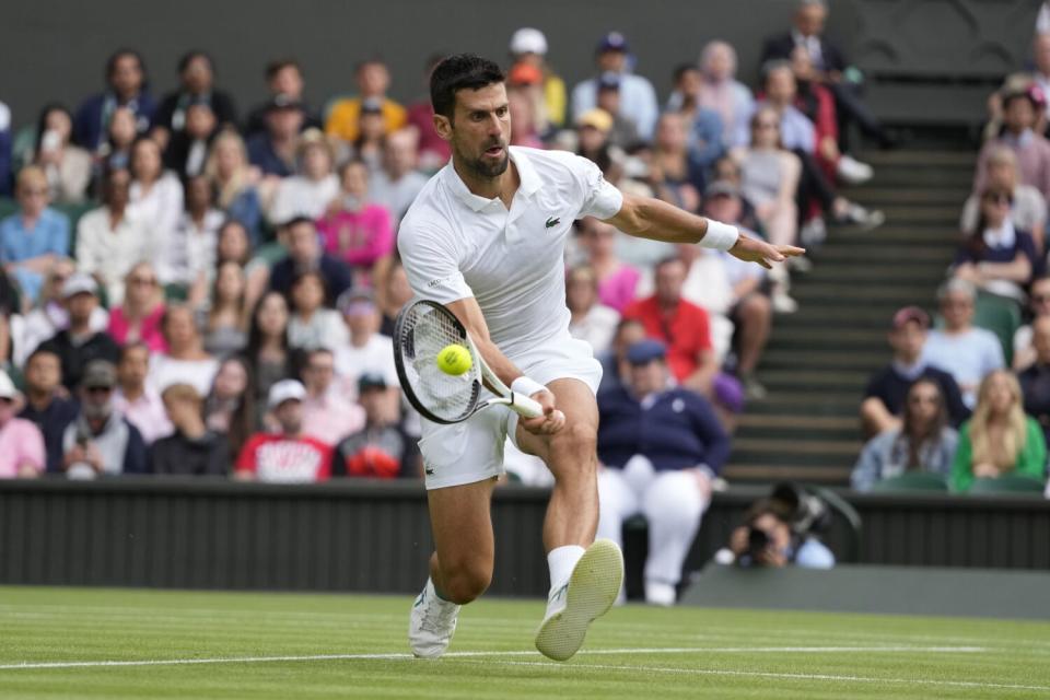 Novak Djokovic volleys a shot at Wimbledon.