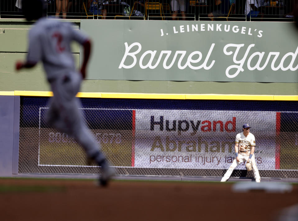 Milwaukee Brewers left fielder Christian Yelich (22) reacts as Minnesota Twins' Michael A. Taylor's rounds the bases during his two run home run during the fourth inning of a baseball game Wednesday, Aug 23, 2023, in Milwaukee. (AP Photo/Jeffrey Phelps)