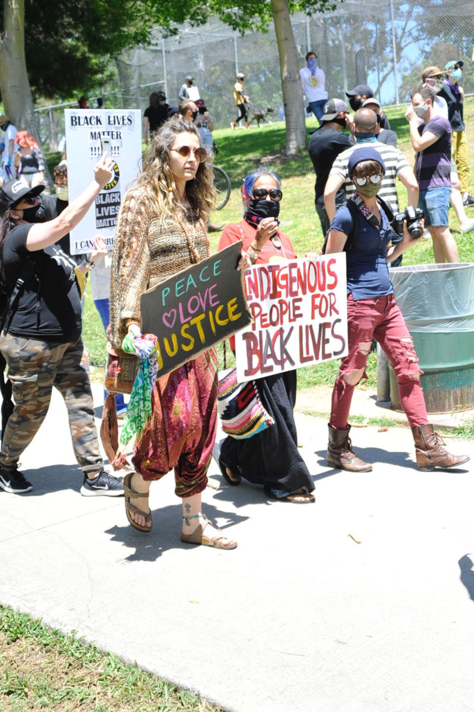 <p>Paris Jackson carries a "Peace Love Justice" sign at a protest in Los Angeles on Saturday.</p>
