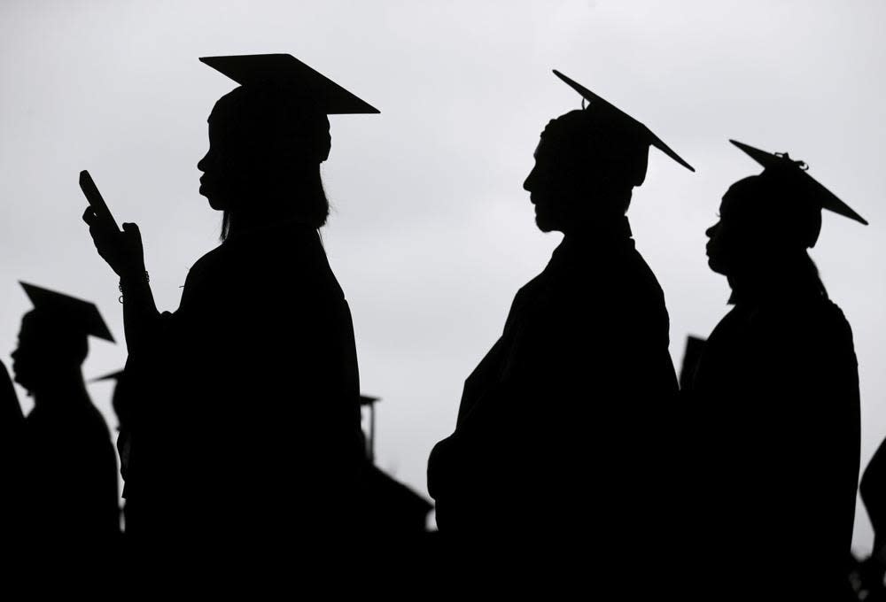 New graduates line up before the start of a community college commencement in East Rutherford, N.J., May 17, 2018. (AP Photo/Seth Wenig, File)