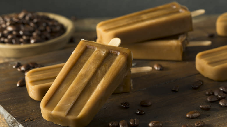 Coffee popsicles on wooden table