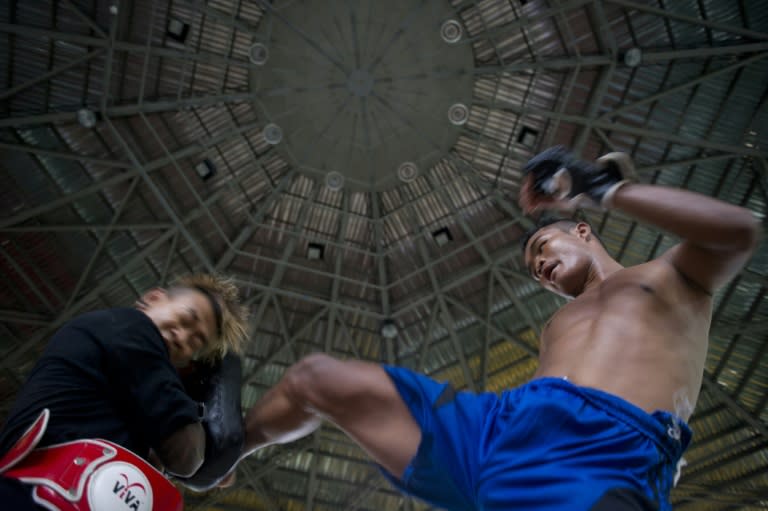 Daw Na Aung (R) practicing Myanmar's homespun martial art Lethwei -- a sport that encourages head-butting and grants victory by knock-out only -- in Yangon