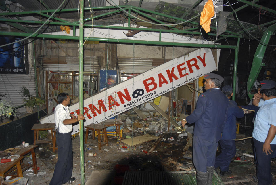 Indian police and rescue workers inspect the site of an explosion in German Bakery close to the Osho Ashram in Pune on. Feb. 13, 2010. (AP Photo)