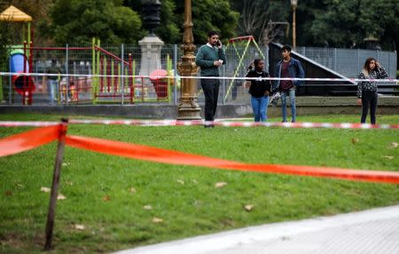 Pedestrians react at the crime scene where Argentine Congressman Hector Olivares was injured and his adviser, Miguel Yadon was killed in an attack near the National Congress in Buenos Aires, Argentina May 9, 2019. REUTERS/Agustin Marcarian