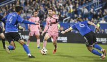 Inter Miami's Lionel Messi (10) pushes forward as CF Montreal's Fernando Alvarez (4) and Samuel Piette (6) defend during the first half of an MLS soccer match Saturday, May 11, 2024, in Montreal. (Graham Hughes/The Canadian Press via AP)