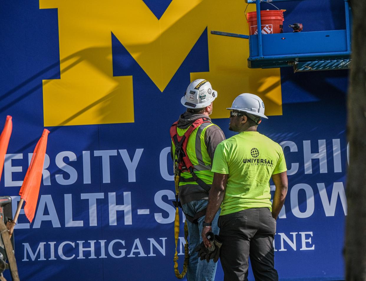Universal Sign Systems workers are preparing the new University of Michigan Health-Sparrow sign that will be placed Saturday, May 4, 2024, approximately ten stories up at the hospital on Michigan Avenue.