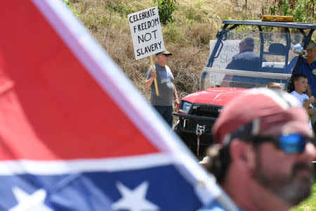 A man protests during a dedication ceremony for a Civil War Confederate Soldier Memorial in Brandenburg, Kentucky, U.S. May 29, 2017. The memorial was recently removed from the campus of the University of Louisville. REUTERS/Bryan Woolston