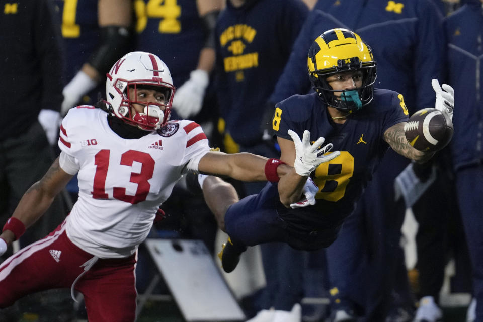 Michigan wide receiver Ronnie Bell (8) tries to make a catch as Nebraska defensive back Malcolm Hartzog (13) defends in the first half of an NCAA college football game in Ann Arbor, Mich., Saturday, Nov. 12, 2022. (AP Photo/Paul Sancya)