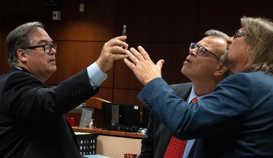 Maricopa County Attorney Thomas Liddy (left) and Kari Lake's Attorneys Kurt Olsen (center) and Bryan Blehm talk during Kari Lake's election challenge trial on May 17, 2023, in Maricopa County Superior Court in Mesa, Ariz.