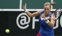 Czech Republic's Petra Kvitova returns a ball to Italy's Roberta Vinci during their Fed Cup semifinal tennis match in Ostrava, Czech Republic, Sunday, April 20, 2014. (AP Photo/Petr David Josek)