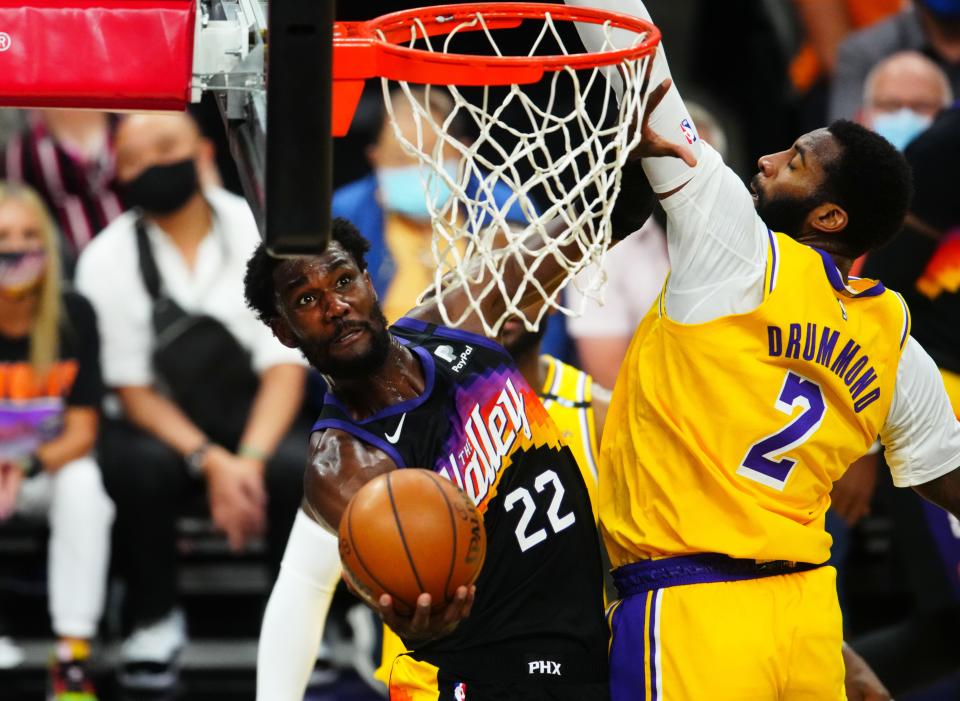 Suns center Deandre Ayton drives to the basket against Lakers center Andre Drummond during the playoffs at Phoenix Suns Arena, May 25, 2021.